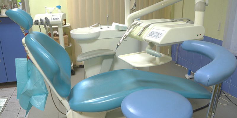 Modern dentist’s chair in a medical room.